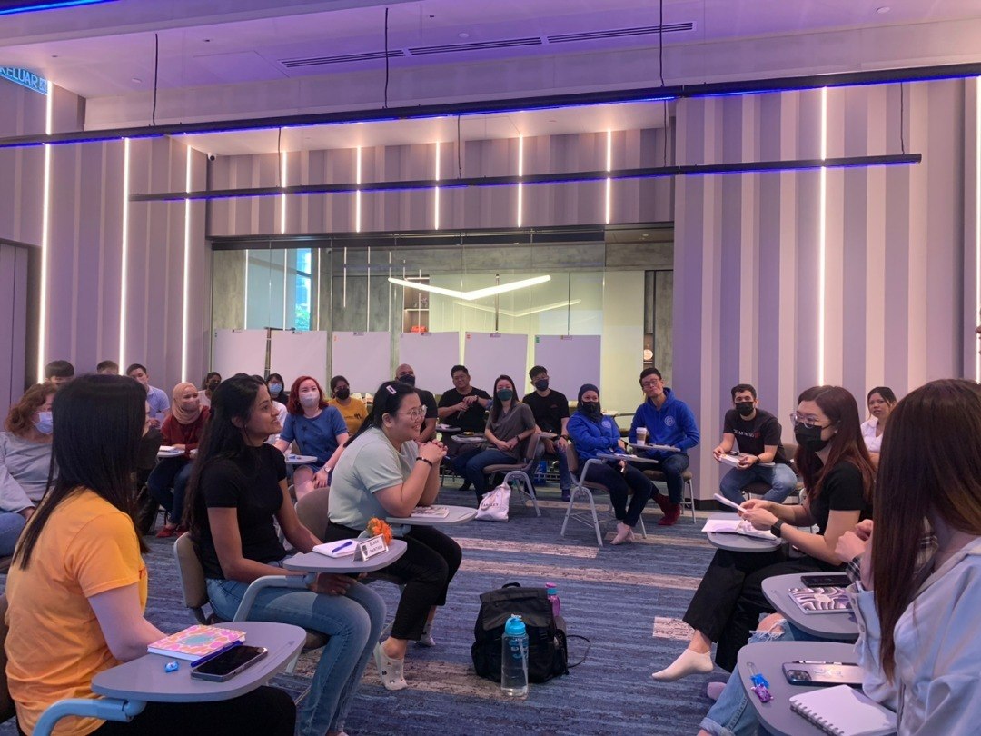 TimesConsult participants seated in an open circle during a workshop discussion